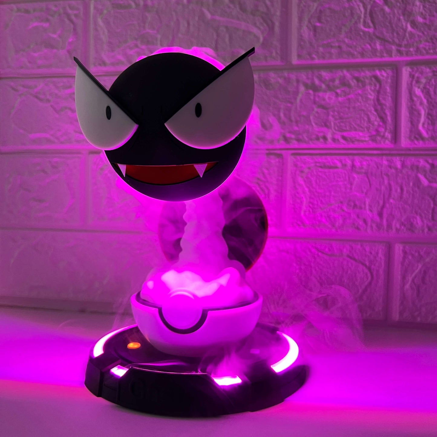Close-up of Gastly-inspired cool mist humidifier with glowing purple light and thick mist effect, bedside desk decor