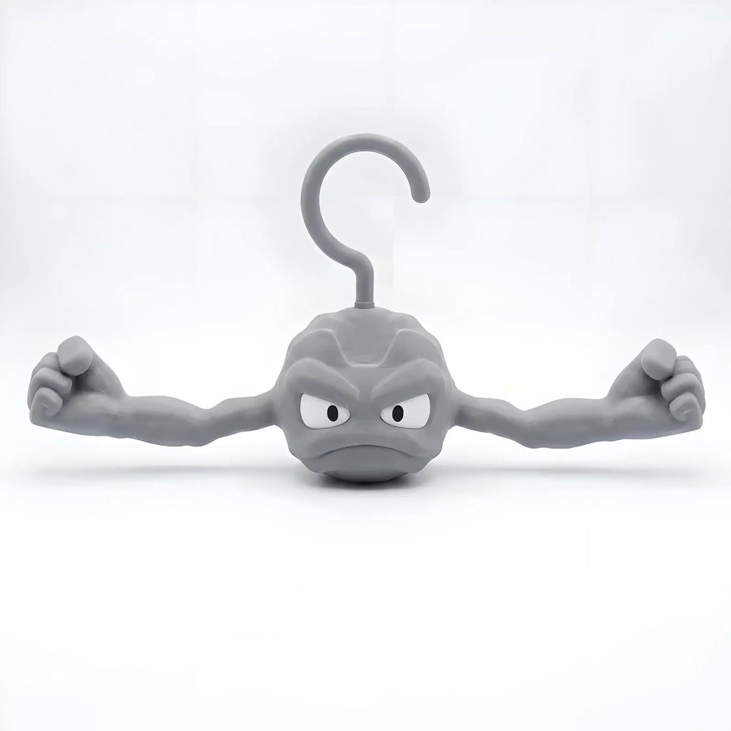 Gray Geodude clothes hanger shaped like the anime rock monster with flexed muscular arms on a white background.