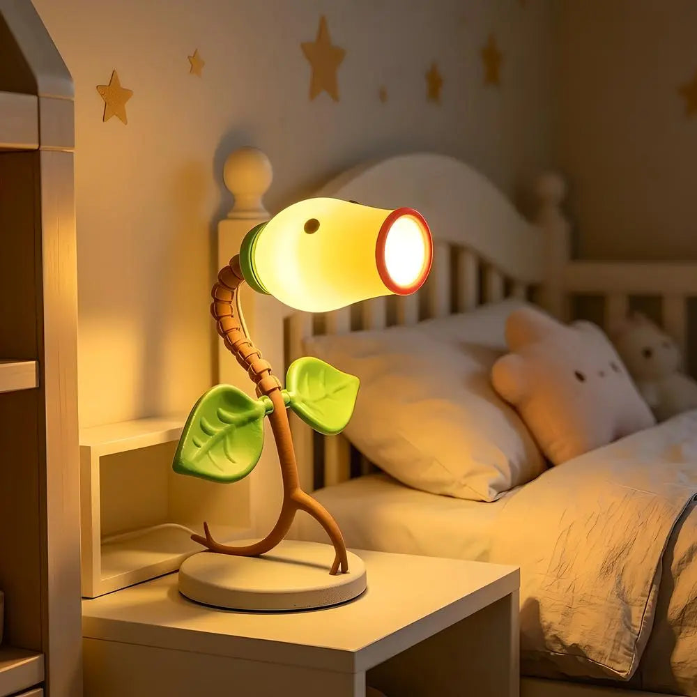 Warm LED Bellsprout night light on a bedside table illuminating a cozy bedroom decor