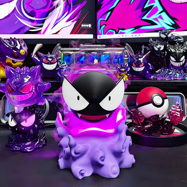 Gastly-inspired humidifier on gaming desk with purple LED glow and mist effect, surrounded by anime figures