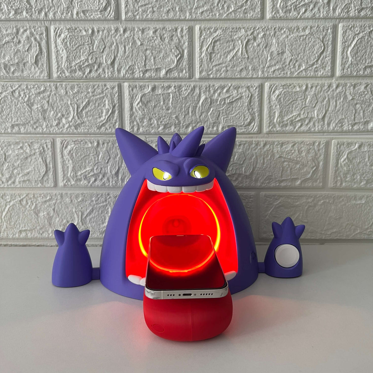 Front photo of Gengar-inspired wireless charger with phone charging, red LED ring light glowing
