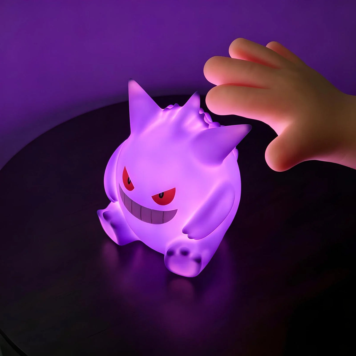 Hand tapping Gengar LED night light to change colors, touch control Pokémon lamp for bedside and kids room use