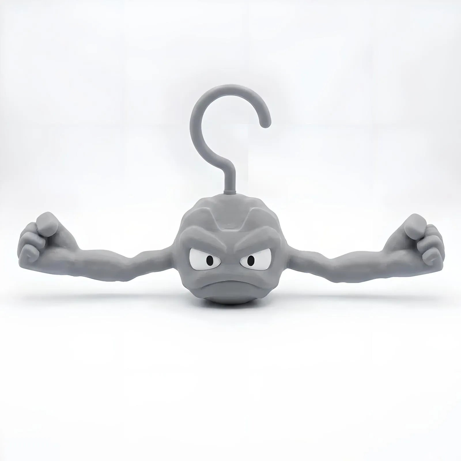 Gray Geodude clothes hanger shaped like the anime rock monster with flexed muscular arms on a white background.