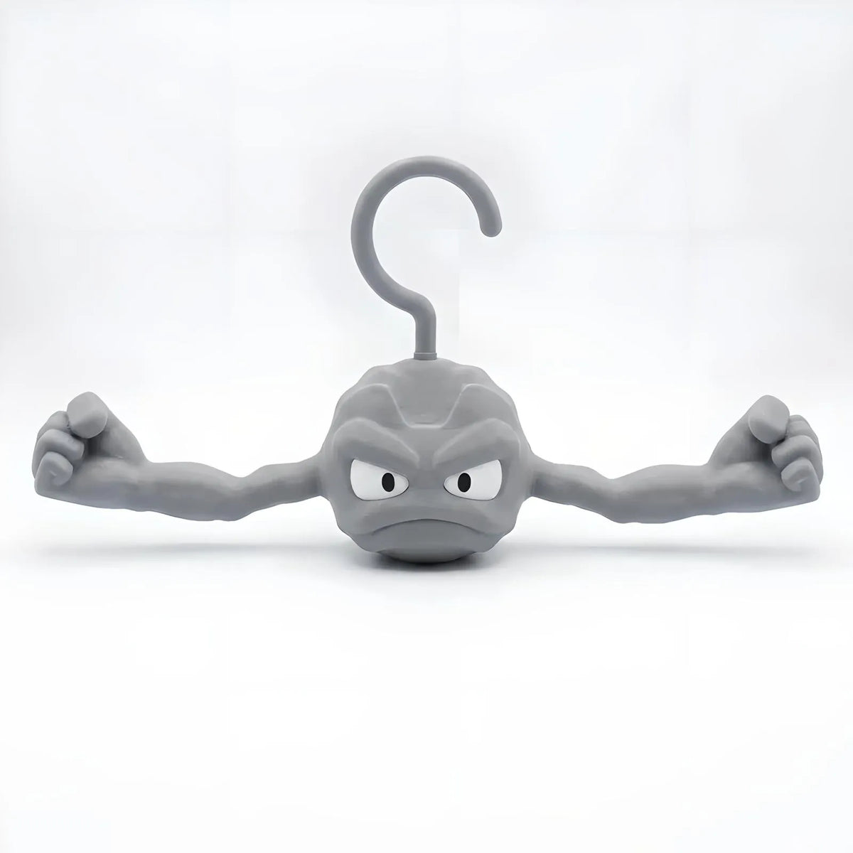 Gray Geodude clothes hanger shaped like the anime rock monster with flexed muscular arms on a white background.
