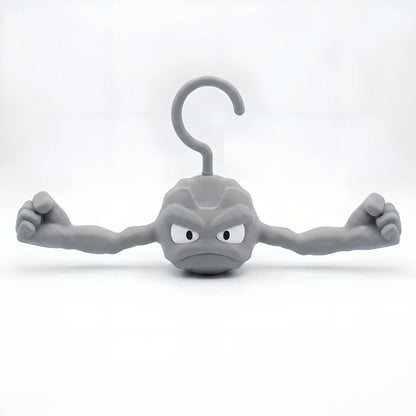 Gray Geodude clothes hanger shaped like the anime rock monster with flexed muscular arms on a white background.