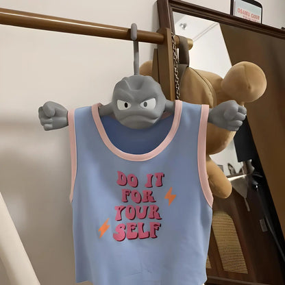 A novelty Geodude coat hanger holding a light blue tank top that reads Do It For Yourself.