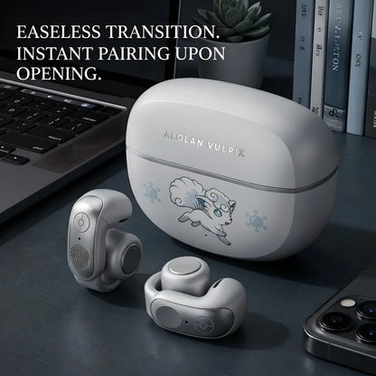 Alolan Vulpix themed white wireless earbuds and charging case placed next to a laptop and smartphone, showcasing instant auto-pairing feature in a modern desk setup.